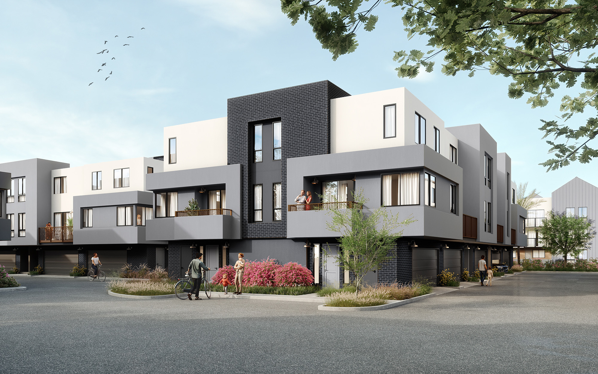 The exterior of our brand new townhomes for rent in San Diego, featuring garages, balconies, and trees.