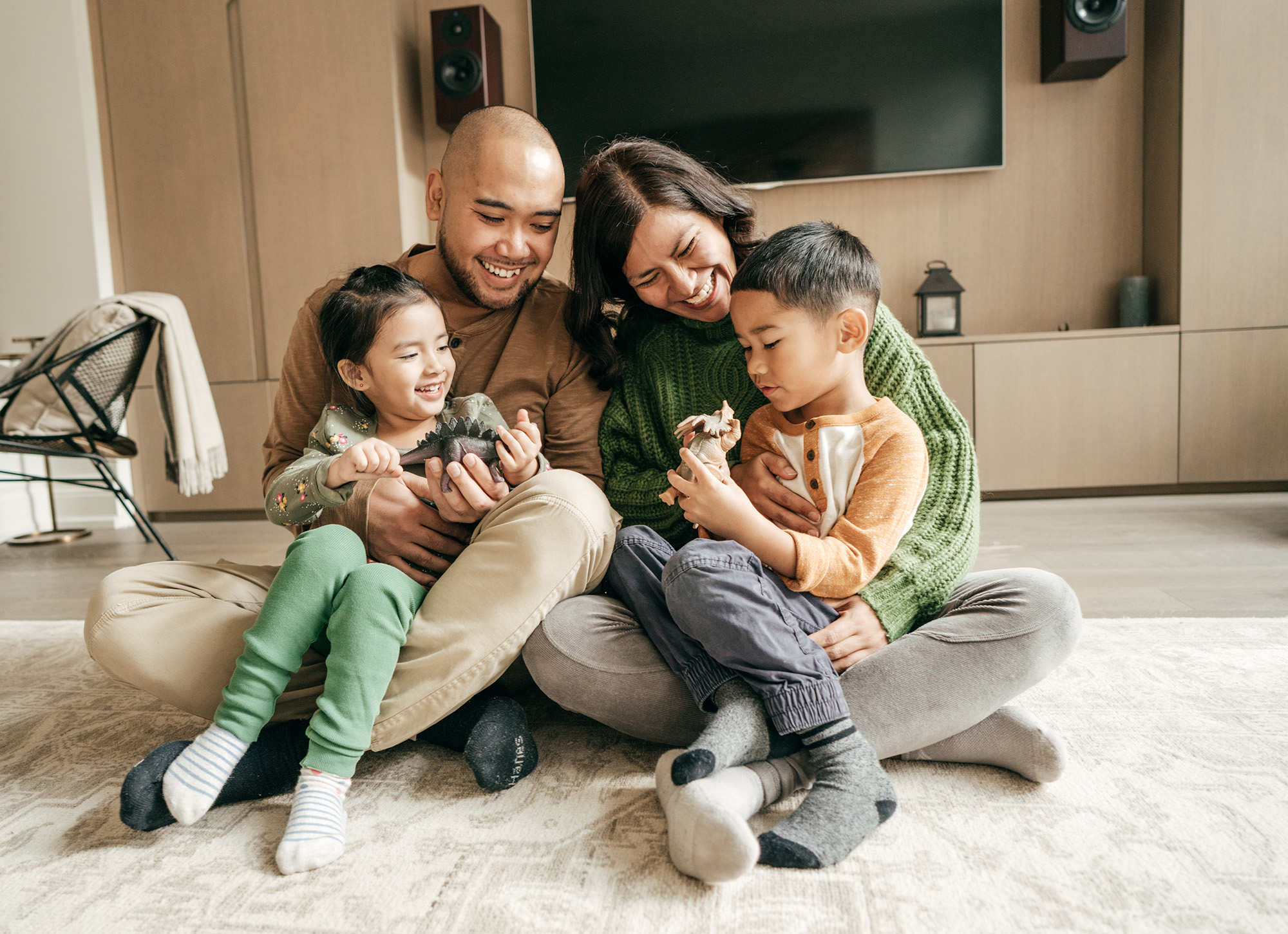 Family sitting on living floor at Mason